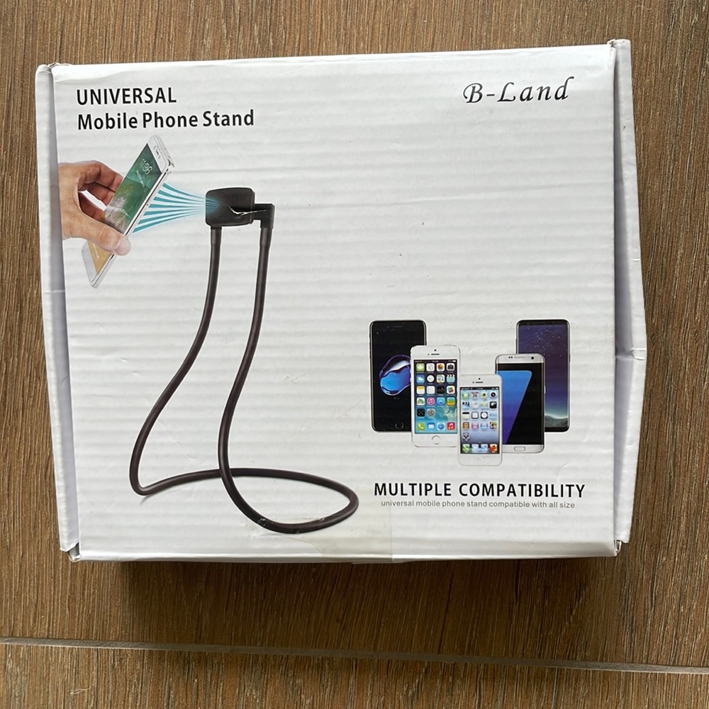 Universal Mobile Phone stand. Fits any size phone. Can sit on table or be worn.